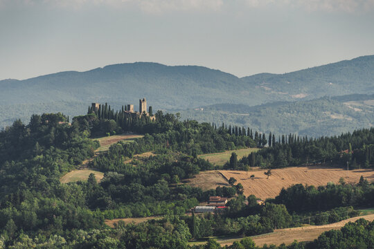 ruins of an ancient medieval castle at sunset in the Tuscan hills