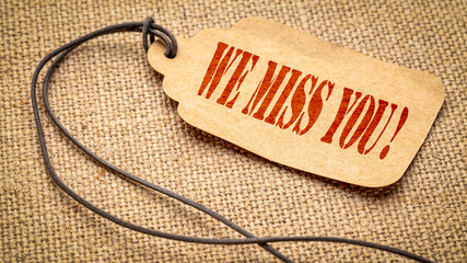 we miss you  - stencil text on a price tag, marketing slogan