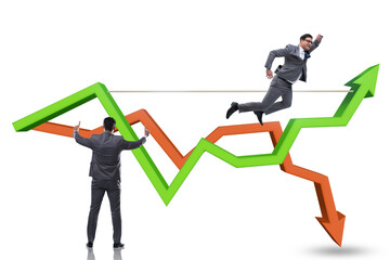 Fototapeta premium Businessman balancing on tightrope on line chart