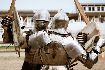 Reenactment of battle with medieval knights in heavy armor on tournament