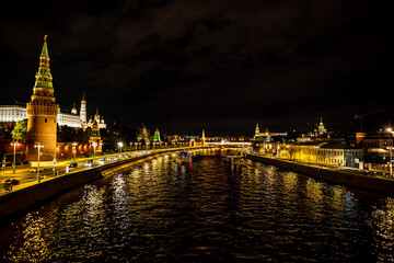Obraz premium landscape with night river lights reflected in the river and the ancient Kremlin with towers on the bank 