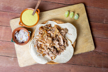 top view of Mexican food. carnitas tacos with sauce and spicy onion