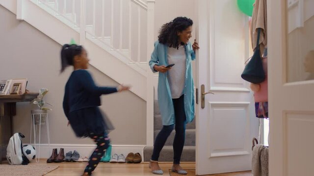 funny birthday party mother opening door with happy children running in house with balloons excited for celebration 4k 