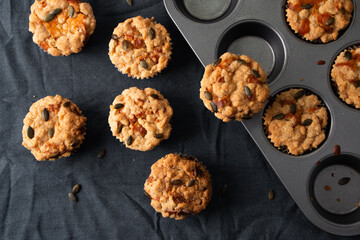 Pumpkin muffins with crumble and seeds in a muffin tin
