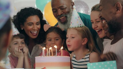 adorable birthday girl blowing candles on cake making wish celebrating party with friends and family children having fun celebration at home 4k footage - Powered by Adobe