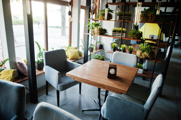 Chairs and table in modern cafe interior.