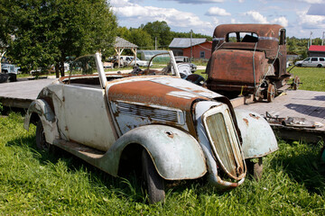 Old abandoned rusty vehicles, crushed cars in junkyard. Cars recycling concept.