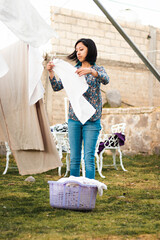 Portrait of a woman hanging linen