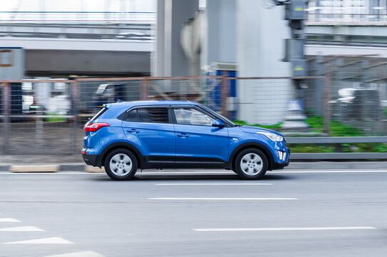 Blue Hyundai Creta first generation car moving on the street. Compliance with speed limits on road concept. Dynamic exterior image