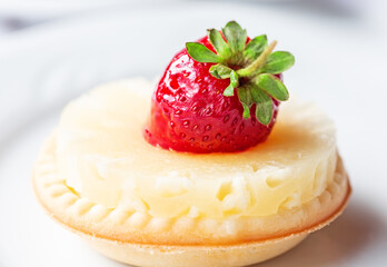 Piece of Strawberry Cake on a white plate with fresh strawberrie.