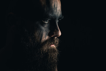 Portrait of a viking warrior with black war paint