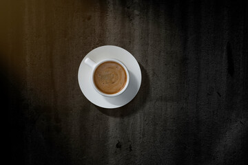 A cup of coffee on the table.  Top view.