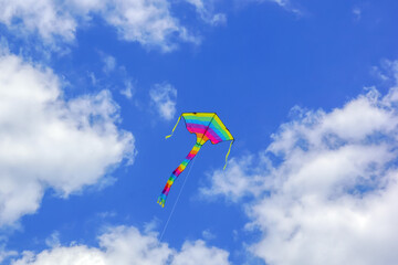 Fototapeta na wymiar a kite with rainbow colors in the sky