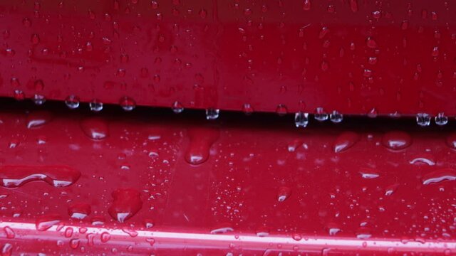 Water drop off on the red car surface 