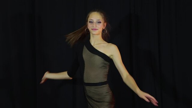 Girl in black cloth actively dance latine