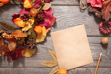thanksgiving day autumn background with autumn leaves on wooden table, free space, blank sheet of...