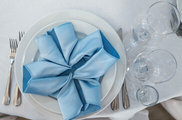 Beautiful table setting on white linen tablecloth. Festive luxury table setting for wedding dinner. Top view