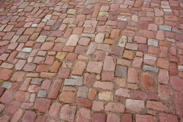 Cobblestone pavement. Stone vintage paved road in perspective