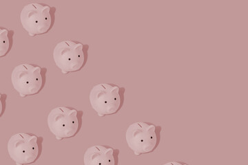 Cute pattern with a piggy banks on a pink background with copy space for your text.