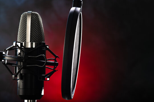 Professional Studio Microphone On A Black-red Background. Close-up. No People. Minimalism. Recording Studio, Vocals, Conversational Genre, Television, Radio Broadcasting.