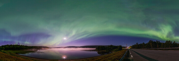 Panoramic Aurora borealis, Northern green lights with full moon and stars in the night sky over...
