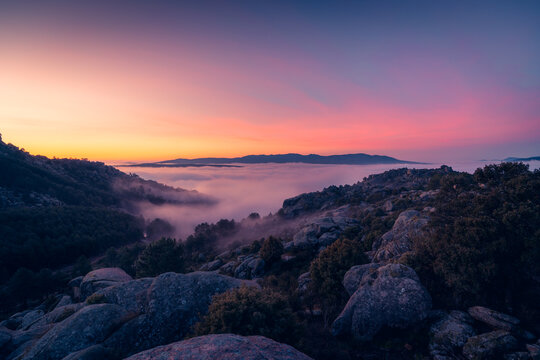 Fog between ridges and boulders at dawn