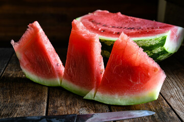 Ripe, sweet, sliced watermelon on a wooden table.