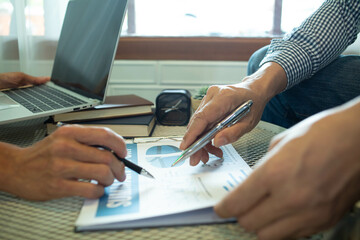 businessman working use laptop in office for discussing documents and ideas , with soft focus, vintage tone