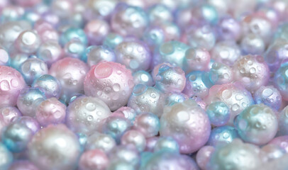 Beautiful background with pearl pearls, top view. Abstract texture for festive backgrounds. Shiny surface of Christmas decorations. Gems close-up. Multicolored bright background.