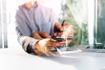 Fototapeta premium Business people using tablets And using his finger to touch the screen With a business graph showing up in a virtual screen.New startup ideas and business growth concept.