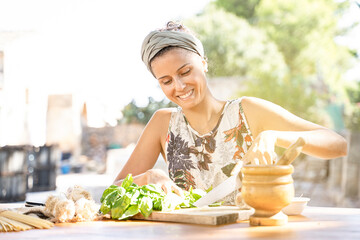 Beautiful young woman is preparing lunch in the outdoor kitchen. Healthy Food