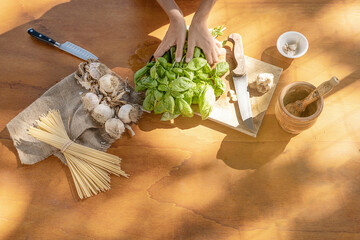 Basil garlic spaghetti and mortar on wooden background