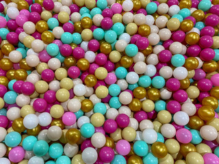 lots of colorful balls in the pool with balls on the playground. Background made of plastic balls. Multicolored plastic