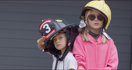 two sisters in firefighter helmets