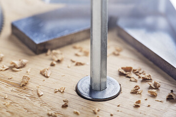 hex bolt screw by hex wrench in wooden oaks plate with with vernier caliper and ruler