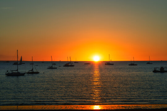 Silhouette of yachts anchored in ocean at sunset, Fannie Bay, Darwin, Northern Territory, Australia