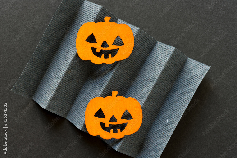 Poster halloween jack o lanterns and pleated gray paper