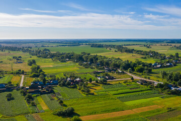 Aerial view over beautiful suburb in  wide valley, in the summer.  Top view to the small village with a beautiful green landscape.