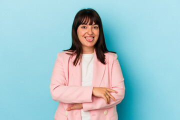 Young curvy caucasian woman isolated on blue background funny and friendly sticking out tongue.