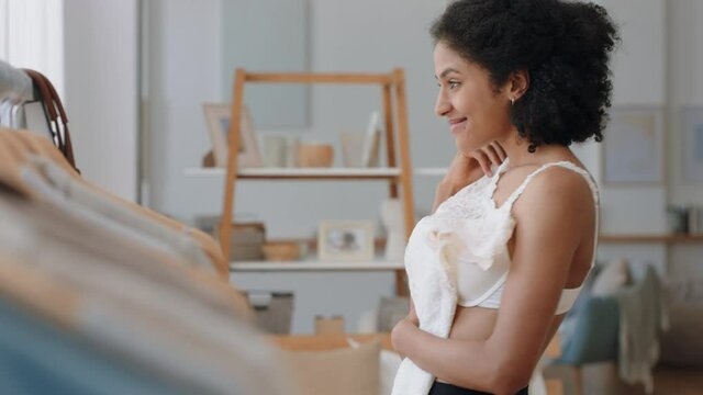 african american woman bride getting dressed looking in mirror with wedding dress at home