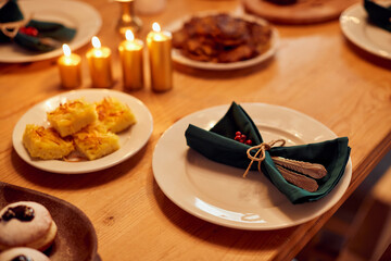 Decorated dining table with traditional Jewish food for Hanukkah.