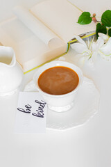 Cup of coffee with milk on white background. Cozy coffee break concept. Breakfast composition.