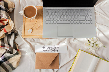 Modern home office desk with laptop, book, tea latte cup on messy bef background. Flat lay, top view. Autumn, fall concept.