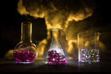 Test glass flask with solution in research laboratory. Science and medical background. Laboratory test tubes on dark toned background , science research equipment concept