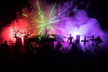 Scary view of zombies at cemetery dead tree, moon, church and spooky cloudy sky with fog, Horror Halloween concept. Toned