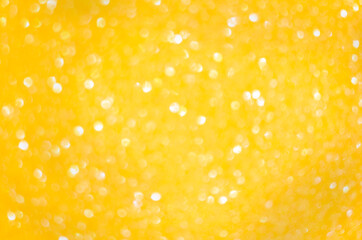 Blurred bokeh made of golden round circles. Abstract background