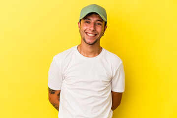 Young caucasian man with tattoos isolated on yellow background  happy, smiling and cheerful.