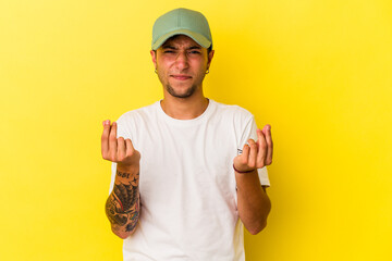 Young caucasian man with tattoos isolated on yellow background  showing that she has no money.