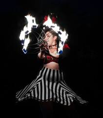 Women Performs in circus outfit with fire ring.
