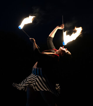 Women Performer attempts to eat fire.